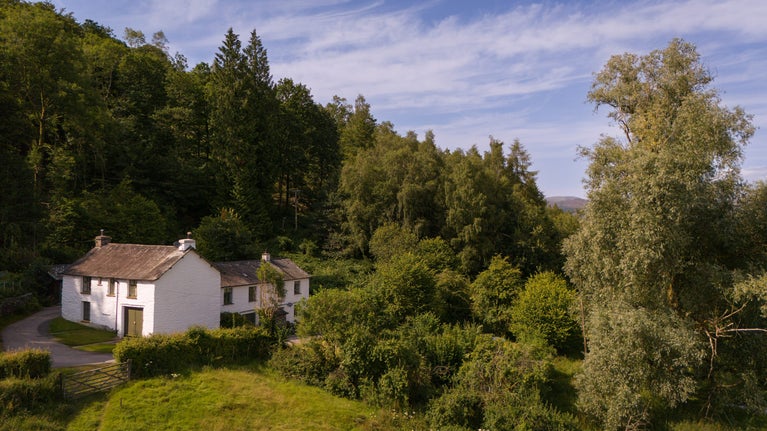The exterior of Restharrow (the building on the right, the two windows on the left of the top row) and neighbours Tanner Brow (on the left) and another home (on the right), Cumbria